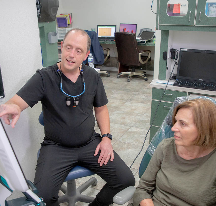 A Premier dentist discussing treatment with a patient
