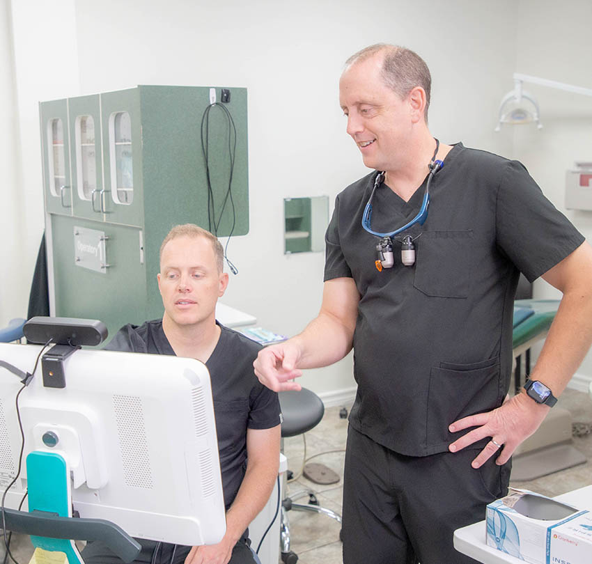 Premier dentists reviewing a digital scan in a treatment room